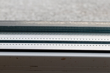 Double glazed window unit with two chambers in a modern home. Energy efficient glass construction helps retain heat, reduce heat loss, and improve indoor thermal comfort during cold seasons.