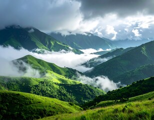 Rolling green mountains covered in lush grass, partly obscured by low-hanging clouds and fog