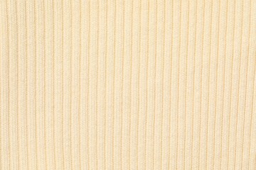 Texture of beige knitted fabric as background, top view