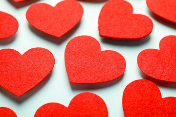 Obraz premium Love. Red decorative hearts on light blue background, closeup