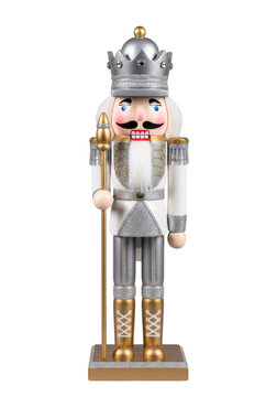ornate wooden nutcracker soldier in a white and silver glitter uniform and jeweled crown, standing on a golden base, isolated against a transparent background. classic christmas holiday concept