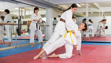Women dressed in kimono practicing body punch and block during group self-defense training