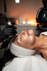 Senior woman receiving professional RF lifting facial treatment focused on skin tightening and age-related skincare.