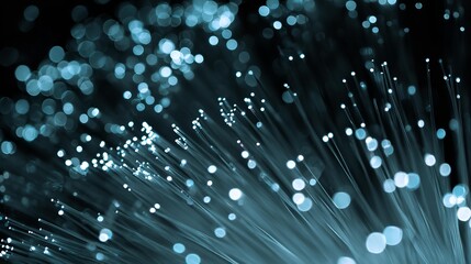 Abstract glowing blue fiber optic cables conveying high speed digital data transmission background art.