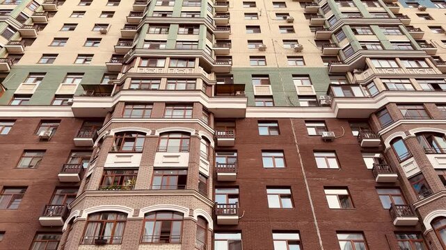 Luxury highrise facade under blue sky, ornate balconies and stone details, upscale neighborhood setting, morning sunlight accentuating decorative cornices and window rows, ideal for real