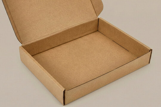Perspective view of an open empty rectangular cardboard mailer box showing interior texture