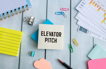 elevator pitch text message on white paper and office supplies, pen, paper note, on white desk. © Uladzislau