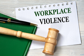 WORKPLACE VIOLENCE - words in white paper against the background of a green folder and a judge's gavel