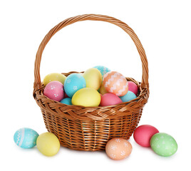 Painted Easter eggs in wicker basket isolated on white