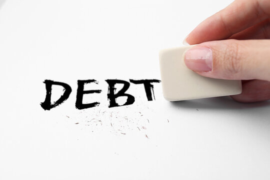 Woman erasing word Debt on white background, closeup