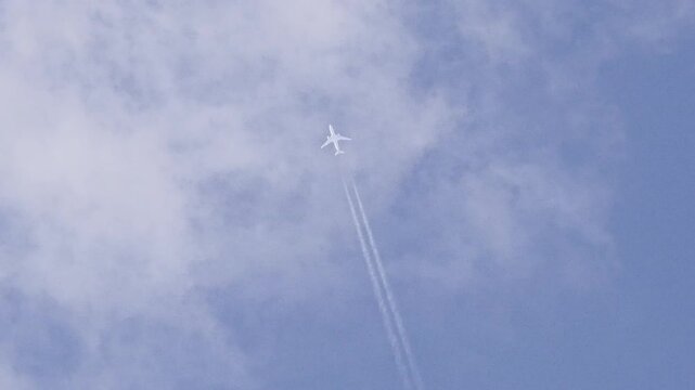 Airbus A350 Flying Through White Clouds at High Altitude with Blue Sky Background