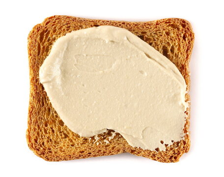 Hummus, chickpea with sesame seeds spread with slice of bread isolated on white background, top view