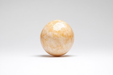 Marble ball sphere with orange and white stone texture isolated on background, smooth polished round shape used as decor element for modern interior design settings