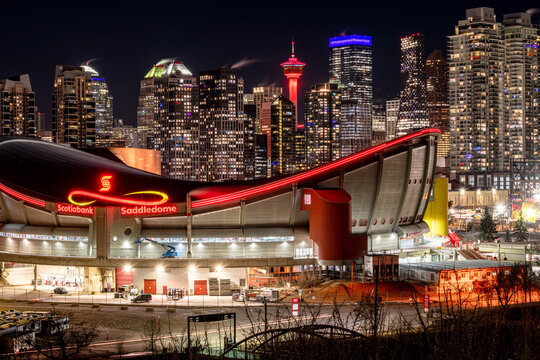 Calgary, Alberta, Canada &ndash; January 18, 2026: Downtown at night, featuring the tower lit in red and the Scotiabank Saddledome in the foreground. The dome is scheduled to be replaced by a new arena.