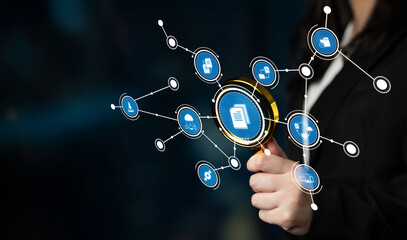 A businesswoman uses a magnifying glass to focus on digital data connections, representing technology role in modern business analysis and insights for performance improvement. Crux