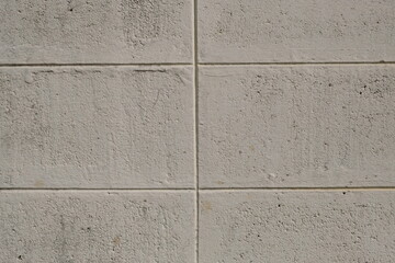 Fototapeta premium Textured concrete block wall surface with horizontal and vertical grout lines