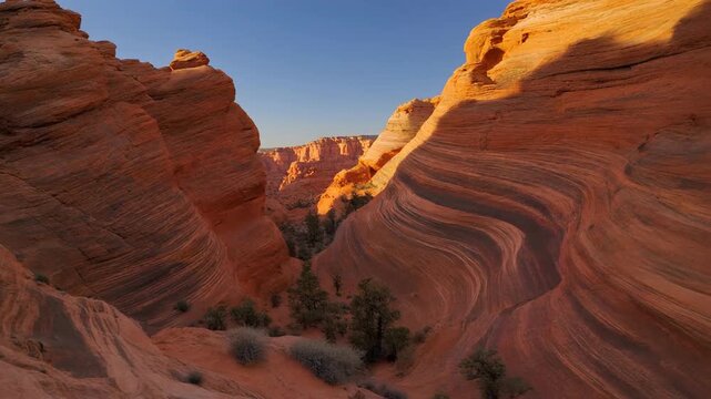 Dramatic landscape with layered sandstone formations at sunset.