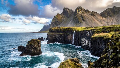 Dramatic landscape with ocean, mountains and waterfall.