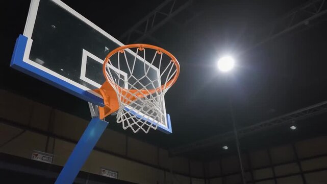 Basketball hoop with backboard indoors against the spotlight