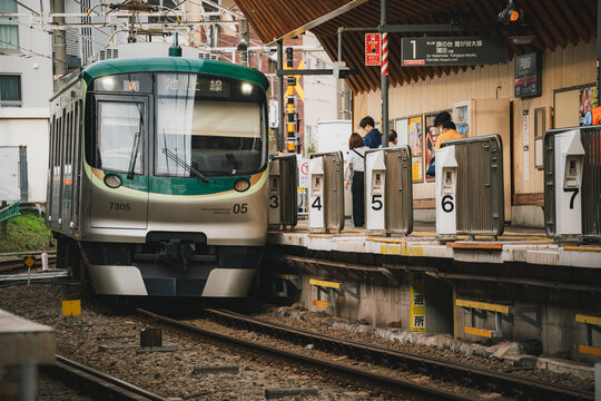 Tokyu 7000 Series Commuter Train Arriving at a Station on the Ikegami Line in Tokyo, Japan