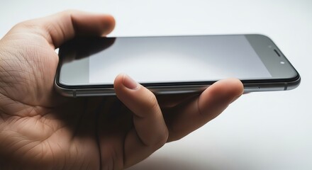 Hand holding smartphone with blank screen