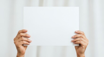 Hands holding blank white paper