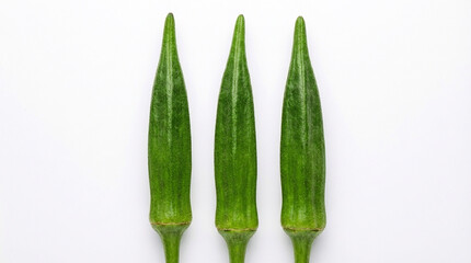 Three fresh green okra pods arranged vertically on a plain white background vegetable food