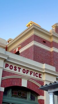 Close Up of Historic Red Brick Post Office Facade at Dusk