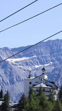 Vertical View of a Cable Car Descending Over Alpine Resort