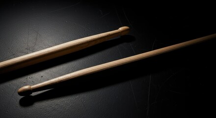 Drumsticks on Dark Surface.