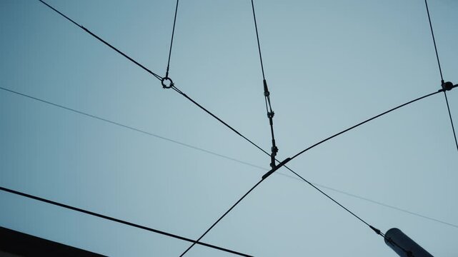 An upward view of the sky where we see trolly support. Dallas, Texas.