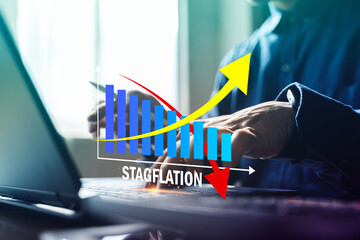 Stagflation economic concept with rising inflation and falling growth bar chart on laptop