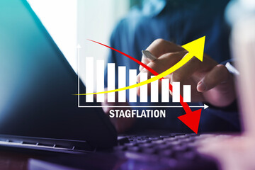 Stagflation concept with rising inflation and falling growth chart on laptop background