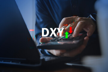 DXY dollar index trading concept with buy sell signals on calculator and laptop