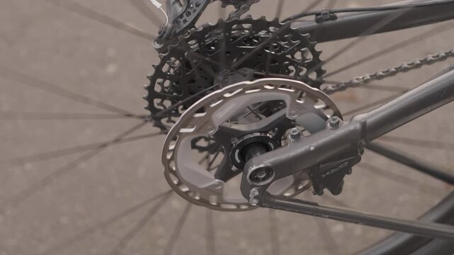 Close up view of bicycle crank chainring and cassette in motion