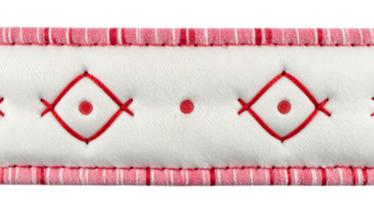Close-up of a padded, white surface with red stitched diamond pattern and striped border