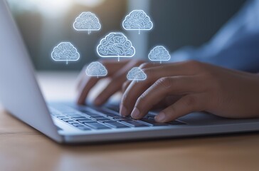 Person typing on a laptop with glowing brain-shaped cloud icons, representing artificial intelligence and cloud computing