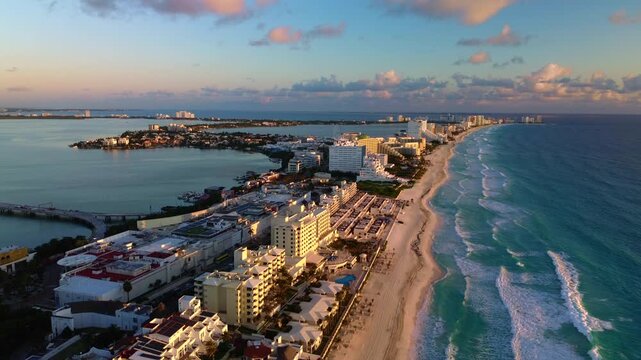 Breathtaking Aerial View of Turquoise Ocean Waves Crashing Along the Pristine Sandy Beaches of Cancun Hotel Zone, Mexico in a Vibrant Summer Paradise