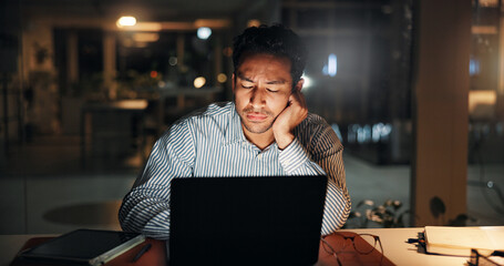 Tired, businessman and night in office on laptop for finance review, deadline and research. Bored,...