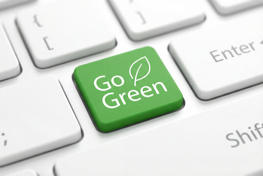 Green Go Green button on modern white computer keyboard key with leaf icon. Concept for environmental protection, sustainable living, eco-friendly technology, and corporate social responsibility (CSR)
