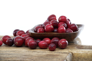Fresh Cranberries on Wooden Scoop Over Rustic Table for Health, Flavor, and Holiday Cheer