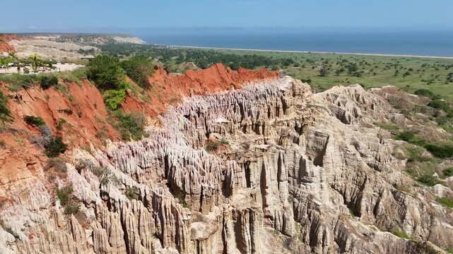 Cinematic drone footage of the unique red cliffs and eroded formations of the Viewpoint of the Moon (Miradouro da Lua) near Luanda, Angola Africa aerial travel destination