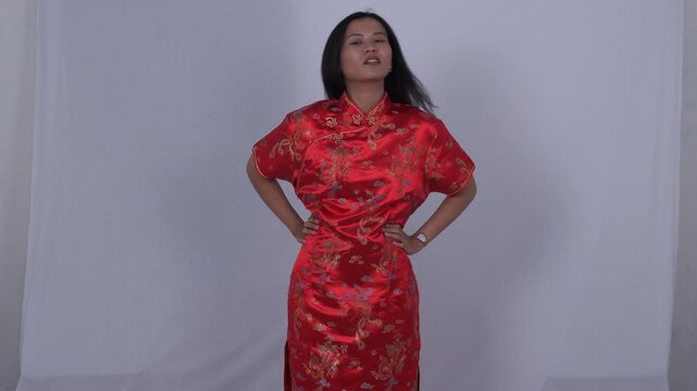 Asian woman in red cheongsam is relieving back pain