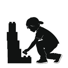 Child building Lego tower silhouette © Monira