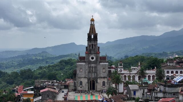 Aerial dolly out revealing colonial church in Cuetzalan, Puebla.