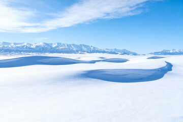 Fototapeta premium Snow-covered landscape with mountain range backdrop