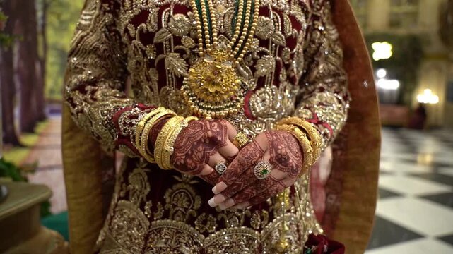 Stunning Pakistani bride dressed in traditional bridal lehenga with heavy gold jewelry
