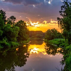 River reflecting a vibrant sunset between green trees under a cloudy sky at twilight