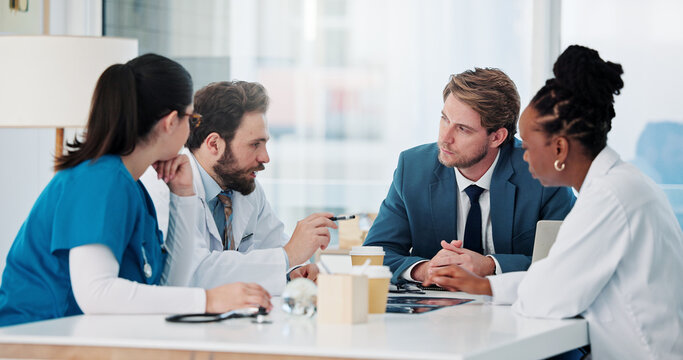 Businessman, doctors and nurse with meeting in hospital for research grant, vaccine trial or planning. Healthcare, people or staff with update on medical funding, investment opportunity or discussion