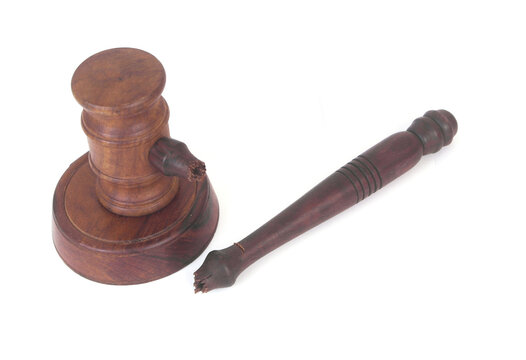 Broken judge gavel isolated on white background. Lawlessness and injustice concept.